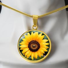 Unique Personalized Sunflower Necklace!   ➜ Add a touch of sophistication and individuality to your style with our Personalized Stainless Steel and 18k Yellow Gold Finish Sunflower Necklace. This stunning necklace combines sleek stainless steel with a luxurious 18k yellow gold finish to create a modern and eye-catching accessory that will make heads turn.  This Sunflower Pendant Is the Perfect Keepsake! Whether for Yourself or a Loved One. ➜ Each necklace is meticulously crafted with high-quality stainless steel and shatterproof liquid glass coating, ensuring durability and a polished, contemporary look. The radiant 18k yellow gold finish adds a vibrant pop of color, making this necklace a true statement piece that reflects your unique personality. But the magic doesn't stop there! Take ad Yellow Flower Necklaces With Birth Flower Detail, Yellow Flower Necklace With Birth Flower Detail, Yellow Birth Flower Pendant Necklace, Yellow Necklace With Birth Flower Pendant, Yellow Flower Jewelry For Mother's Day, Yellow Round Sunflower Jewelry, Yellow Flower Shaped Jewelry With Sunflower Print, Yellow Sunflower Print Jewelry For Gift, Yellow Flower-shaped Jewelry With Sunflower Print