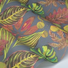 a close up view of a fabric with colorful leaves on the back and side of it