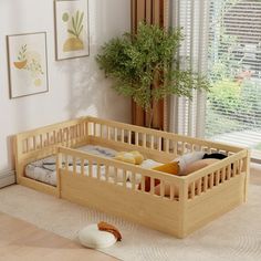 a baby crib in the corner of a room with a potted plant on the floor