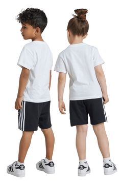 A bold Trefoil design dominates a kid-sized T-shirt that's paired with matching shorts finished with signature 3-Stripes racing down the sides. Shorts have elastic/drawstring waist; side-seam pockets 70% cotton, 30% recycled polyester Machine wash, tumble dry Imported Cotton Three Stripes Streetwear Shorts, Adidas Cotton Shorts With Three Stripes Branding, Adidas Cotton Shorts With Three Stripes, Adidas Cotton Relaxed Fit Shorts, Adidas Relaxed Fit Cotton Shorts, White Cotton Shorts With Three Stripes, White Cotton Adidas Shorts, Adidas Kids, Size 4t