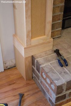 a brick fireplace being built with tools on the floor and in front of it is an inset