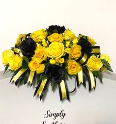 a bouquet of yellow and black flowers on top of a white sign that says simply southern