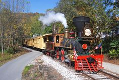 an old fashioned train traveling down the tracks