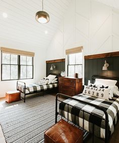 a bedroom with two beds and a rug on the floor