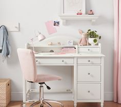 a white desk topped with a pink chair next to a window