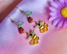 From my Backyard Wildlife collection! 🦋 A pair of lovely fairycore dangle earrings featuring a tiny bee with rhinestones, honeycomb, cute ladybug and transparent green glass leaf 🌿 🐝  - in gold tone. These earrings will be absolutely perfect for any fan all things fairy, garden, nature, cottagecore aesthetic, insect and other woodland creatures lovers. They can make a creative gift for any pixie in your life :) ️  I have many cottage or fairy core themed earrings: mismatched bee and honeycomb Nature Cottagecore, Ladybug Earrings, Cute Ladybug, Bee Honeycomb, Aesthetic Gift, Insect Jewelry, Cottagecore Aesthetic, Woodland Creatures, Fairy Core