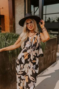 - Kick back and enjoy some vacay vibes in this stylish jumpsuit! - Unlined material with an abstract floral print - A v-cut neckline with a twist detail - Adjustable spaghetti straps - A smocked upper back with a tie detail - A wide legged jumpsuit with floor length hemlines Black Jumpsuits And Rompers For Spring Beach Outings, Black V-neck Summer Jumpsuits And Rompers, Black V-neck Summer Jumpsuit, Black Floral Print Jumpsuits And Rompers For Vacation, Black Floral Print Jumpsuit For Vacation, Black Jumpsuits And Rompers For Spring Vacation, Chic Black Jumpsuits And Rompers For Beach Season, Chic Black Jumpsuit Or Romper For Vacation, Chic Black Jumpsuits And Rompers For Vacation