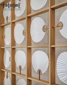 the wall is decorated with white paper fans