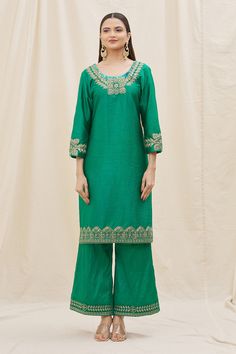 Green kurta with embroidered neckline and cuffs crafted in silk. Comes with flared pant and contrast dupatta.
Components: 3
Pattern: Embroidery
Type Of Work: Sequins, Zari, Thread work
Neckline: Scoop
Sleeve Type: Three quarter
Fabric: Kurta and Pant: Silk, Dupatta: Organza
Color: Green,Peach
Other Details: 
Floral embroidery
Dusty peach dupatta
Occasion: Mehendi and Haldi - Aza Fashions Peach Dupatta, Contrast Dupatta, Dusty Peach, Kurta Pant Set, Silk Kurta, Pattern Embroidery, Embroidered Neckline, Kurta With Pants, Silk Dupatta