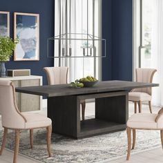 a dining room with blue walls and white chairs