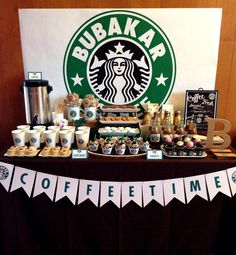 a table topped with lots of coffee cups and desserts next to a starbucks sign