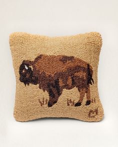 an embroidered bison pillow on a white background