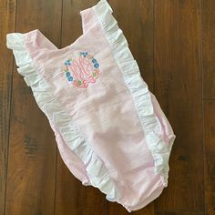 Precious Monogrammed Pink Seersucker Sunsuit/Swimsuit From Cecil & Lou. Size 6. Has Ahg Mono On Chest. Bottons In Back Have Two Options For The Best Fit. Fully Lined. Sold As “Swimsuit”, But Not Sure How Well The Fabric Would Hold Up In Water. Would Be Perfect For Pictures On The Beach! New Without Tags, As My Daughter Never Got A Chance To Wear! Summer Cotton Swimwear With Ruffles, Fitted White Bubble Romper For Beach, Pink Cotton Swimwear For The Pool, Pink Cotton Bodysuit For Beach, Seersucker Swimwear For Summer Beach, Summer Seersucker Swimwear, Playful Fitted Bubble Romper For Beach, Playful Fitted Bubble Romper For The Beach, Seersucker Swimwear For Beach In Summer