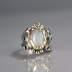 "Moonstone Ring, Garnet Ring, 9K Yellow Gold Hammered Queen Ring in Sterling Silver Band, Gemstone Ring, Antique Style Ring, Chunky Ring This garnet and moonstone ring looks like it was made for a queen. It is ornate but delicate, statement piece but not oversize. The band is adjustbale to any finger size and made of sterling silver set with dark red natural garnet gemstone. The center is a bezel set moonstone gemstone and 9K solid gold, welded on sterling silver, hammered around the moonstone. Queen Rings, Antique Style Rings, Magical Stones, Chunky Ring, Ring Antique, Chunky Rings, Garnet Ring, Garnet Rings, Garnet Gemstone