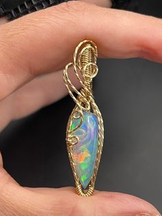 This beautiful Ethiopian Opal gold filled pendant is about 1 1/4 inches tall and 1/2" wide, it includes a 18" gold filled necklace and in a gift box, ready for gifting! These are not costume pieces that will chip away or rust over time. They will last forever if taken care of, which is why I include a free polishing cloth with every order.  All of my pieces are made with high quality wire from Rio Grande. Quality is very important to me! Message me, If you have any questions, I'm happy to help. Wire Wrapped Round Pendant Jewelry As Gift, Elegant Hand Wrapped Pendant Jewelry, Wire Wrapped Pendant Jewelry Gift, Wire Wrapped Pendant Jewelry For Gifts, Hand Wrapped Teardrop Pendant Jewelry Gift, Hand Wrapped Round Pendant Jewelry As Gift, Gold Jewelry For Anniversary, Hand Wrapped Spiritual Jewelry For Anniversary, Spiritual Hand Wrapped Jewelry For Anniversary