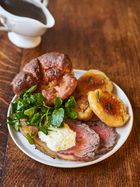 a white plate topped with meat and veggies