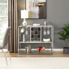 a silver shelf with wine glasses and fruit on it