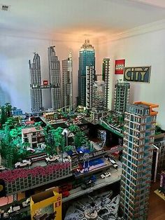 a model city is shown with cars and buildings in the foreground, including skyscrapers