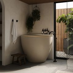 a bath tub sitting next to a wooden bench