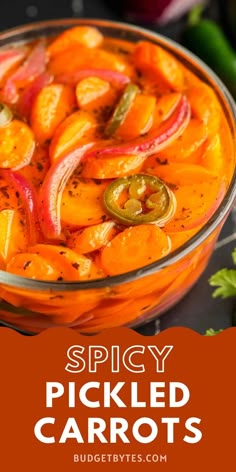 spicy pickled carrots in a glass bowl with peppers and cilantro on the side