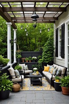 an outdoor living area with couches, tables and potted plants on the patio