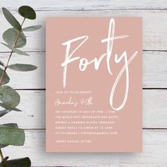 a pink and white party card with the word forty on it, surrounded by greenery