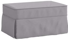 a grey ottoman with a cover on it