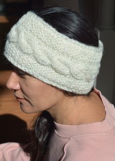 a woman wearing a white knitted headband