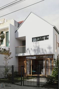 a white house with a black fence around it