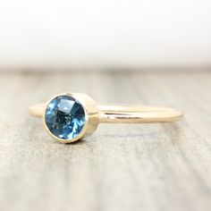 Genuine London Blue Topaz Stacking Ring made with 14K gold filled. Also available in .925 sterling silver. Crafted with love and attention to detail, these rings are made of high-quality 14k gold filled with a beautiful finish. They effortlessly blend durability with a refined aesthetic, ensuring they will be cherished for years to come. 💛 The colors will not chip off or fade and can be worn in water. This ring is made to order in your size. If you don't see your size available please feel free Minimalist Topaz Gemstone Ring For Everyday Wear, Minimalist Topaz Birthstone Ring, Minimalist Topaz Ring For Everyday, Minimalist Topaz Birthstone Jewelry, Everyday Fine Jewelry Sapphire Birthstone Ring, 14k Gold Sapphire-color Topaz Ring, 14k Gold Blue Topaz Ring, Minimalist Blue Topaz Solitaire Jewelry, Everyday Sapphire Birthstone Ring