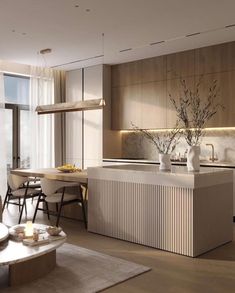 a modern kitchen with an island and dining area