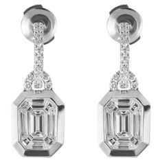 These timeless, classic and beautiful emerald illusion diamond earrings can easily become a family heirloom considering its quality design will stand the test of time. Each earring is set in platinum and contains 9 shaped baguette diamonds that are perfectly matched and assembled to recreate the look of an emerald cut diamond without a huge price. These dangle earrings also have a pave hoop and in total they contain 4.83 carat total Diamonds. These earrings are comfortable and secure with a push back. Luxury Emerald Cut Diamond Earrings With Baguette Diamonds, Luxury Baguette Cut Earrings For Engagement, Luxury Evening Baguette Cut Earrings, Luxury Marquise Baguette Diamond Earrings, Luxury Bridal Earrings With Baguette Diamonds, Radiant Cut Diamond Earrings, Baguette Diamond Earrings, Baguette Earrings, Emerald Earring