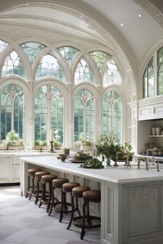 a large kitchen with many windows and stools