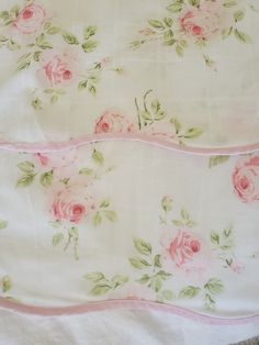 two bedspreads with pink roses on them