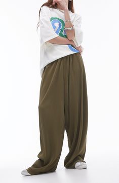 Go for chic volume in these roomy pants cut from gorgeous plissé fabric for textural intrigue. 28" inseam; 20" leg opening; 16" front rise; 19" back rise (size Medium) Elastic waist 100% polyester Machine wash, line dry Made in Turkey Spring Oversized Wide-leg Harem Pants, Oversized Wide Leg Harem Pants For Spring, Oversized Green Wide-leg Pants, Spring Oversized Solid Wide Leg Pants, Oversized Green Wide Leg Pants, Baggy Pleated Wide-leg Pants, Baggy Wide Leg Harem Pants With Pull-on Style, Oversized Wide Leg Parachute Pants For Spring, Pleated Relaxed Fit Wide Leg Pants