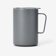 a gray coffee mug with a handle is shown on a white background, it appears to be empty