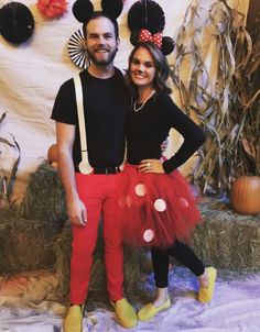 a man and woman in mickey mouse costumes