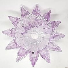 a purple glass flower on a white background