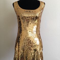 Bebe Mini Dress Never Worn. Body: 80% Rayon, 20% Spandex. Trims: 92% Nylon, 8% Spandex. Hand Wash Glamorous Sleeveless Stretch Mini Dress, Glamorous Fitted Sleeveless Mini Dress, Fitted Sleeveless Midi Dress For Party Season, Glamorous Fitted Sleeveless Sequin Dress, Glamorous Fitted Sleeveless Midi Dress, Chic Gold Sleeveless Dress, Fitted Sequin Sleeveless Dress For Night Out, Fitted Sleeveless Sequin Evening Dress, Sleeveless Stretch Bodycon Dress With Sequins