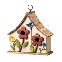 a bird house with flowers painted on it