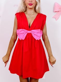 Bow Me Away Red Dress | Sassy Shortcake | sassyshortcake.com Playful Pink V-neck Dress, Red Sleeveless Dress With Bow, Pink Sleeveless Mini Dress With Bow Tie Back, Flirty Pink Dress With Bow, Flirty Pink Mini Dress With Bow, Summer Party Dress With Red Bow, Pink Mini Dress With Bow Tie Back, Playful Pink Dress With Bow, Party V-neck Mini Dress With Bow Tie Back