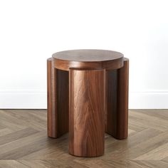 two wooden stools sitting on top of a hard wood floor