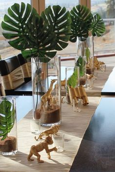 several vases filled with plants and animals on a table