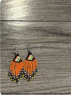 These gorgeous earrings are designed and produced in Kwazulu-Natal. Orange Beaded Drop Earrings For Pierced Ears, Traditional Orange Drop Earrings, Orange Beaded Round Earrings, Orange Teardrop Earrings With Dangling Beads, Orange Round Bead Earrings, Southwestern Red Beaded Dangling Earrings, Unique Orange Drop Earrings, Unique Orange Earrings With Dangling Beads, Beaded Parrot Earrings