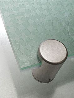 a white toilet sitting in a bathroom next to a bath tub with a glass top