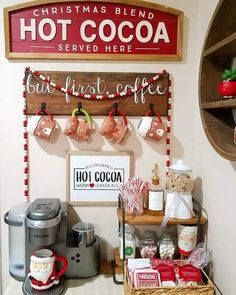 a coffee bar with hot cocoa and christmas decorations on the wall above it, along with other holiday themed items