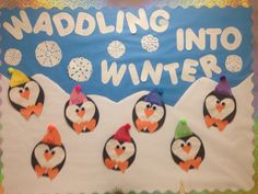 a bulletin board with penguins and snowflakes on it that says waddling into winter