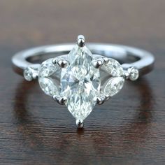 an engagement ring with three pear shaped diamonds