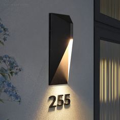 a house number sign mounted to the side of a building