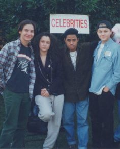 a group of people standing next to each other in front of a sign that says celebrities